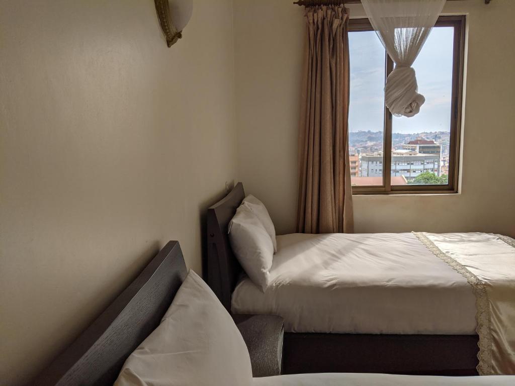 Postel nebo postele na pokoji v ubytování Prestige Hotel Suites