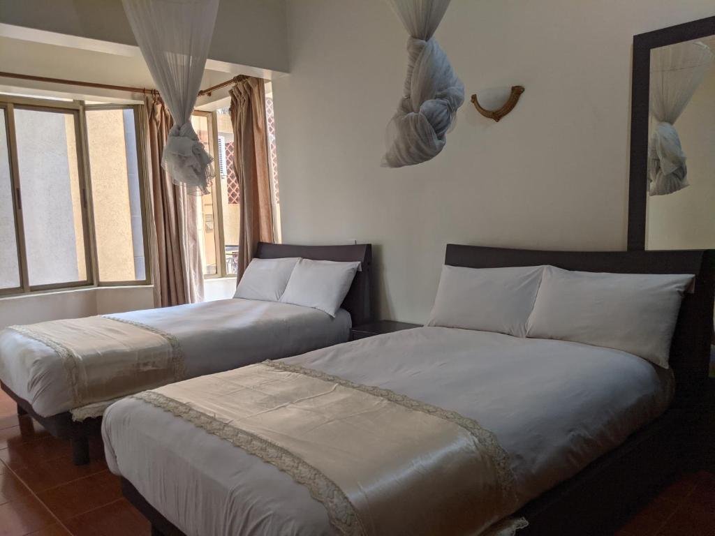 Postel nebo postele na pokoji v ubytování Prestige Hotel Suites
