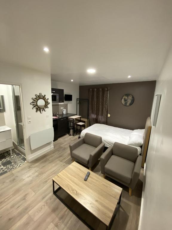 a bedroom with a bed and a living room at Lh Rooms Location in Le Havre