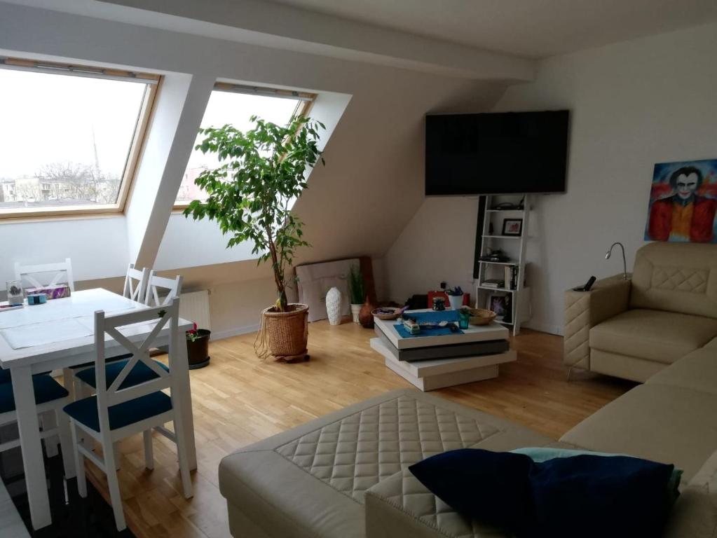 a living room with a couch and a table at Apartament Agiczar in Giżycko