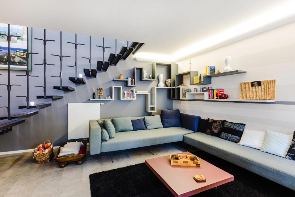 a living room with a blue couch and shelves at Lago Welcome Clausen II in Luxembourg