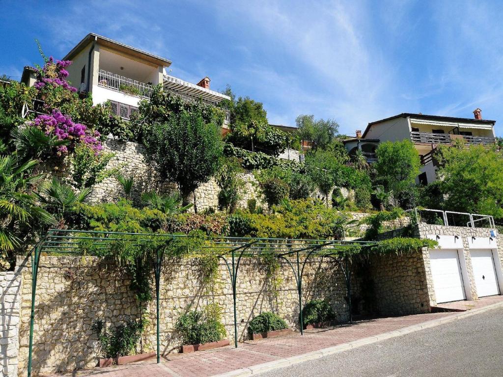 a building with plants on the side of it at Apartments Mandica in Rabac