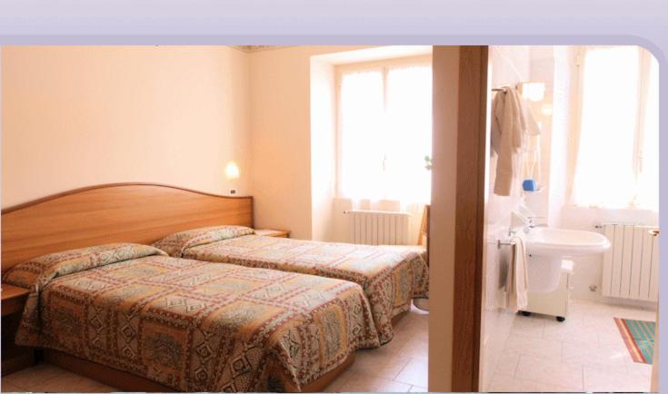 Postel nebo postele na pokoji v ubytování Hotel Brisino