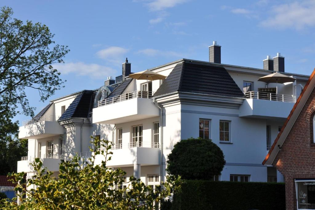 a white house with a black roof at Whg 12 Viktoria Luna Ostseeflair in Zingst