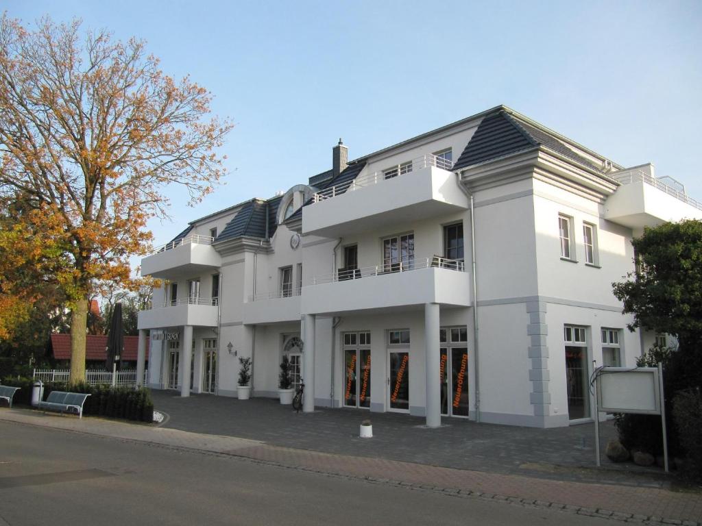 a white building on the side of a street at Viktoria Luna WE 8 Kuestenzauber in Zingst