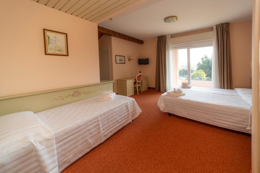 Postel nebo postele na pokoji v ubytování Hotel Della Torre
