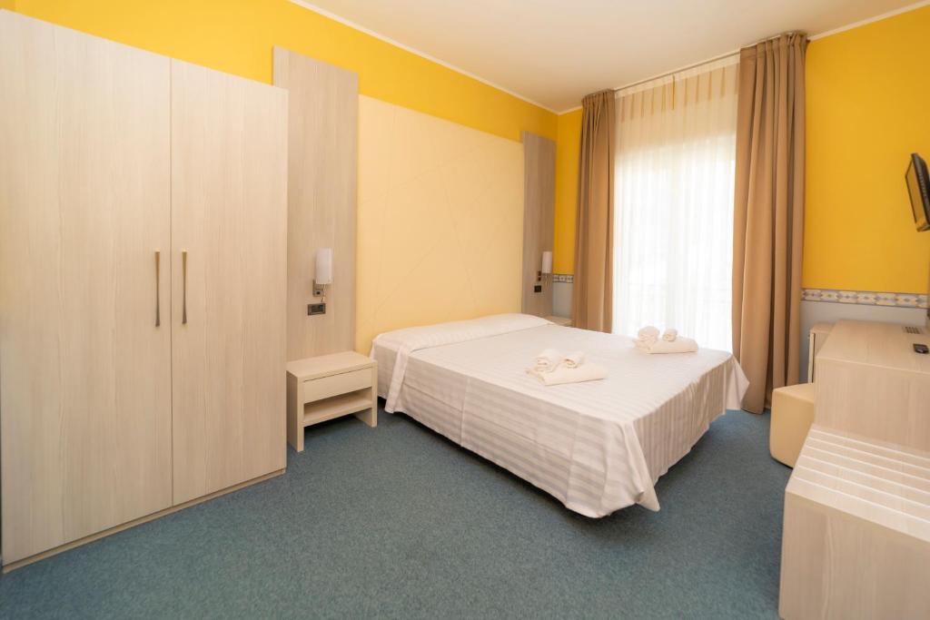 Postel nebo postele na pokoji v ubytování Hotel Della Torre
