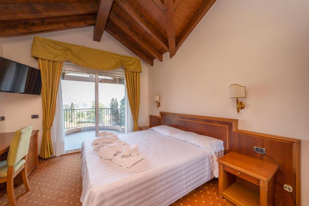 Postel nebo postele na pokoji v ubytování Hotel Della Torre