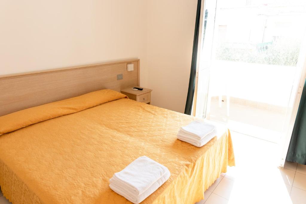 Postel nebo postele na pokoji v ubytování Hotel Capitano