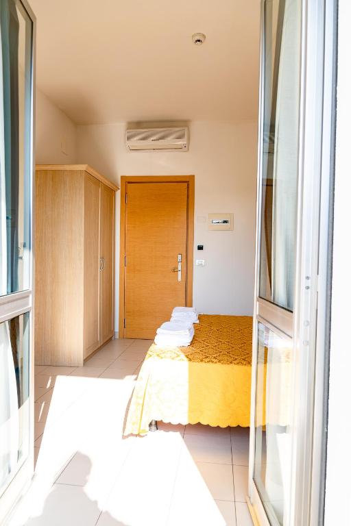 Postel nebo postele na pokoji v ubytování Hotel Capitano