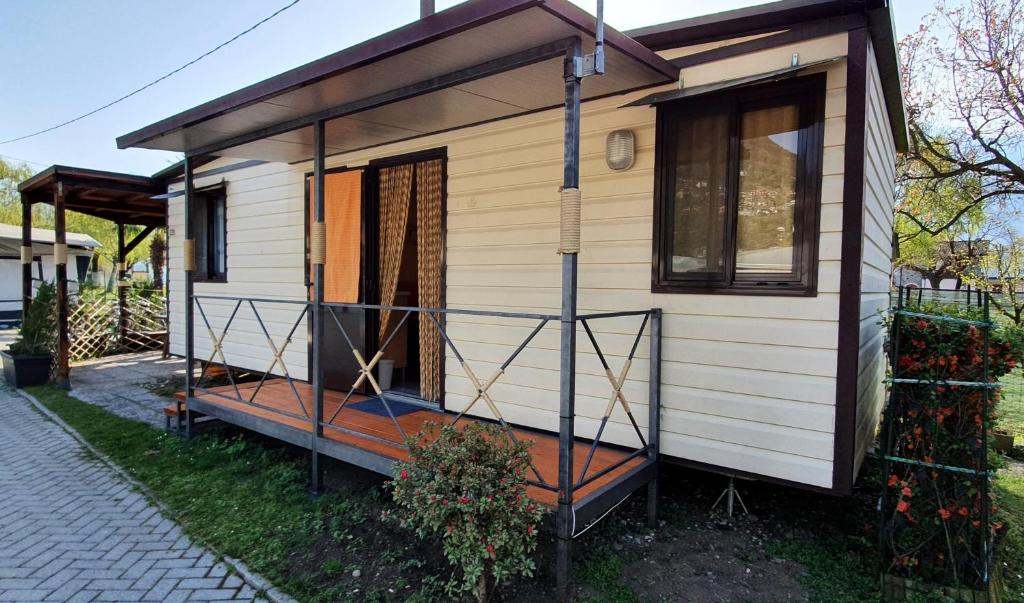 a tiny house sitting on the side of a street at Camping Italia90 Caravan&Bungalow in Domaso