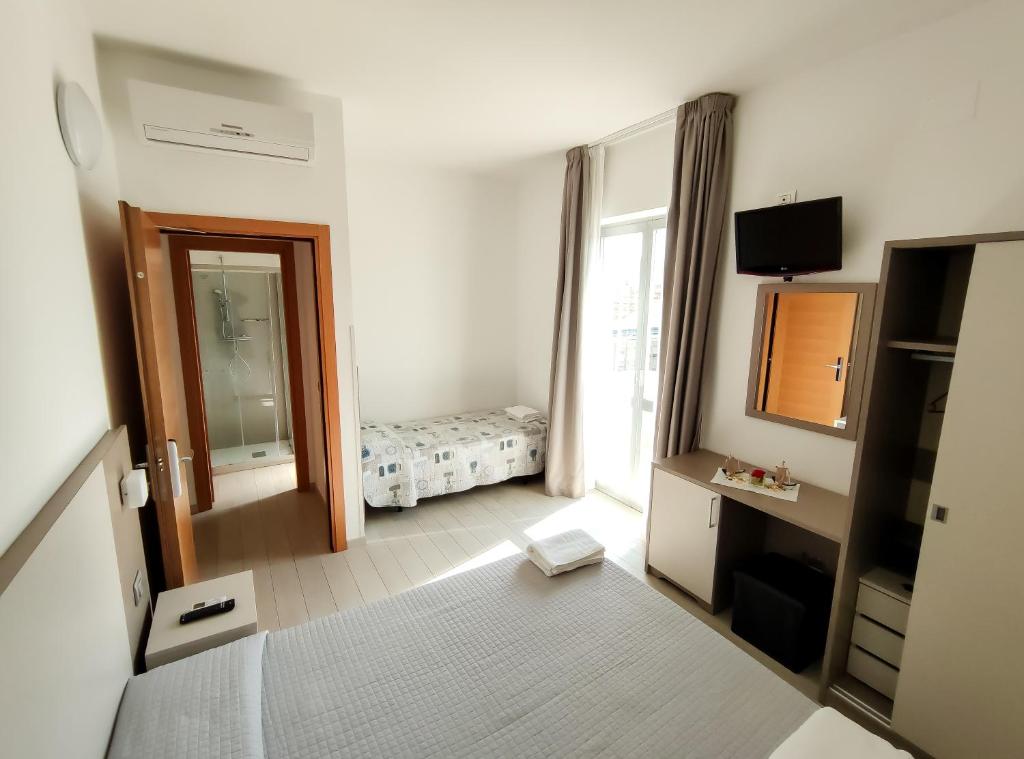 Postel nebo postele na pokoji v ubytování Hotel Capitano
