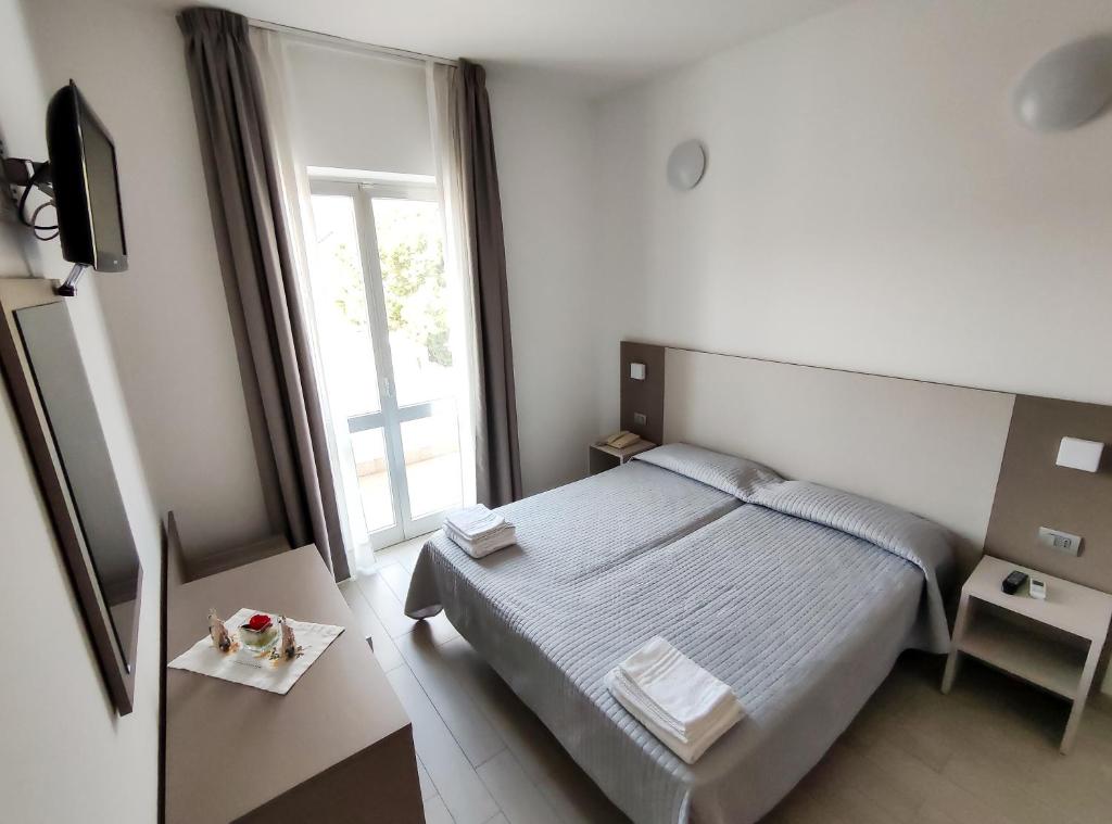 Postel nebo postele na pokoji v ubytování Hotel Capitano