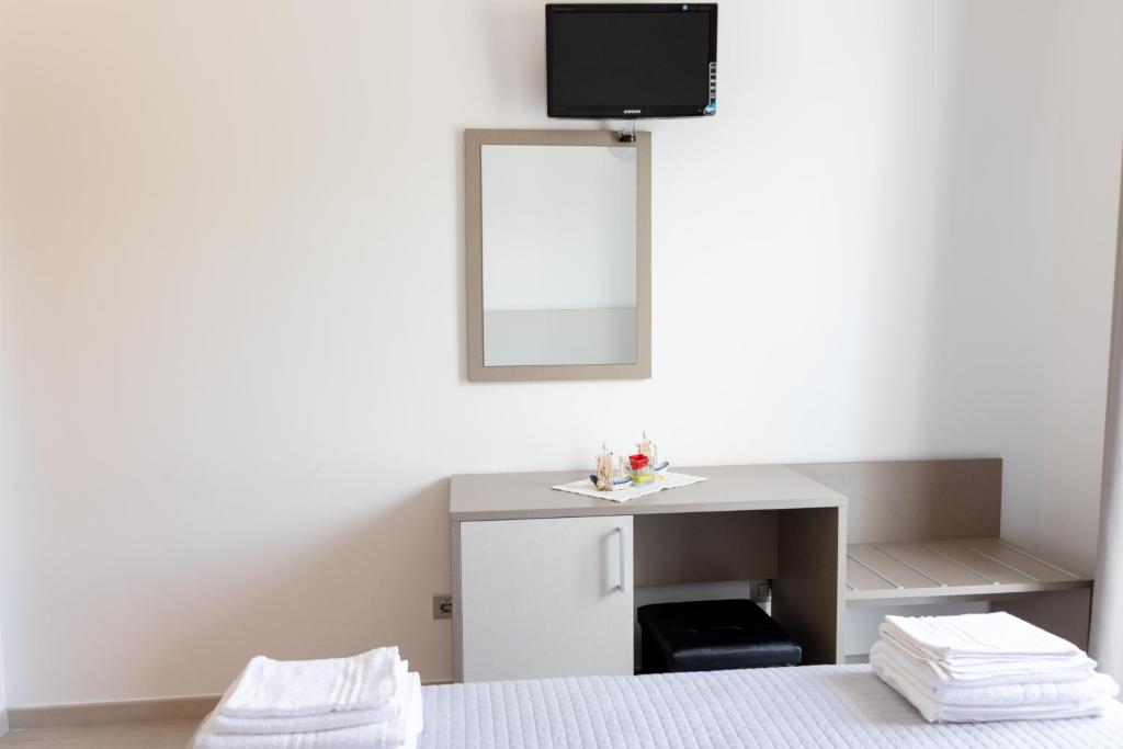 Postel nebo postele na pokoji v ubytování Hotel Capitano