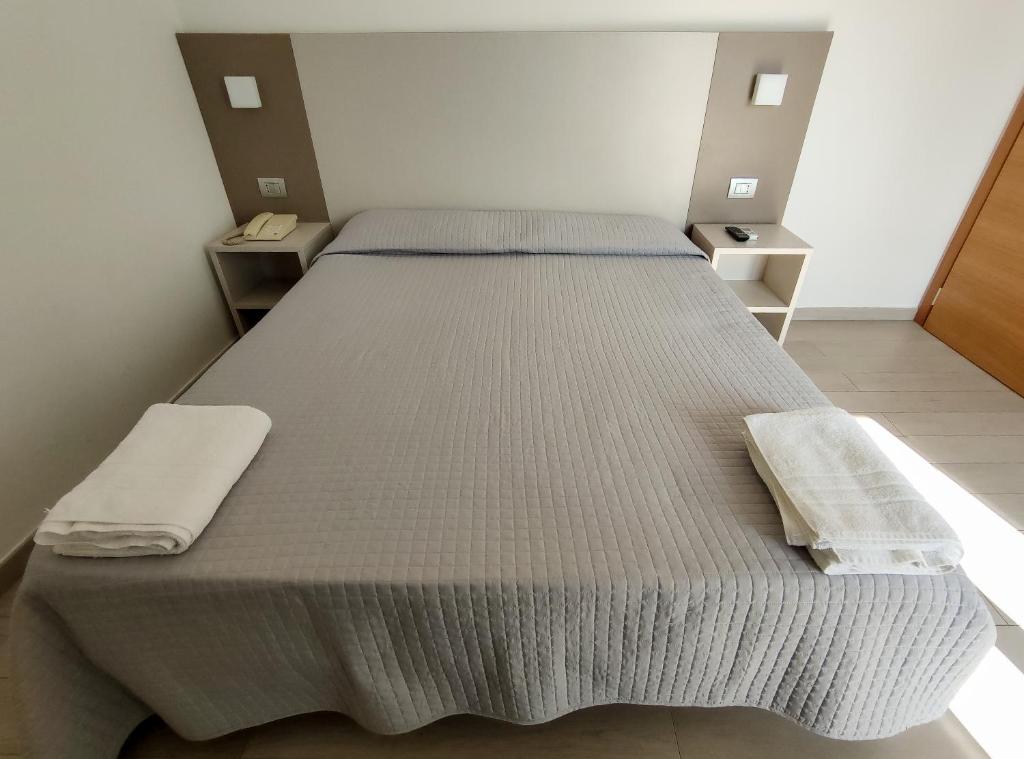 Postel nebo postele na pokoji v ubytování Hotel Capitano