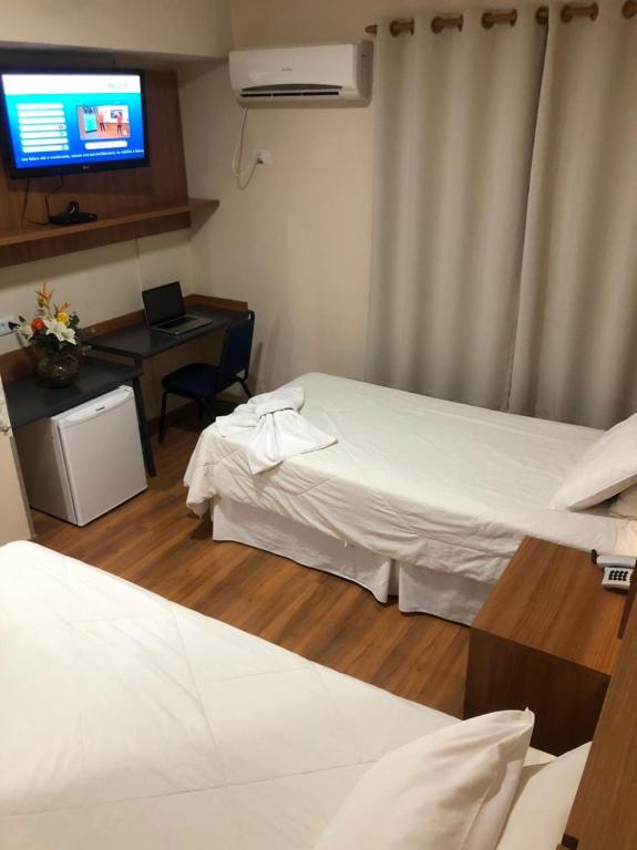 Postel nebo postele na pokoji v ubytování Hotel Aero Park e Estacionamento