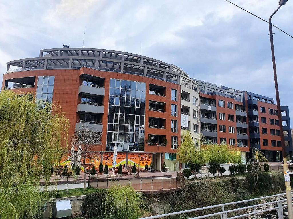 a large brick building with a curved roof at "При братята" - Apartments & Studios in Sandanski