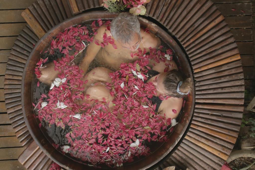 a group of naked people in a bowl of flowers at Paraty Paradiso in Parati-Mirim