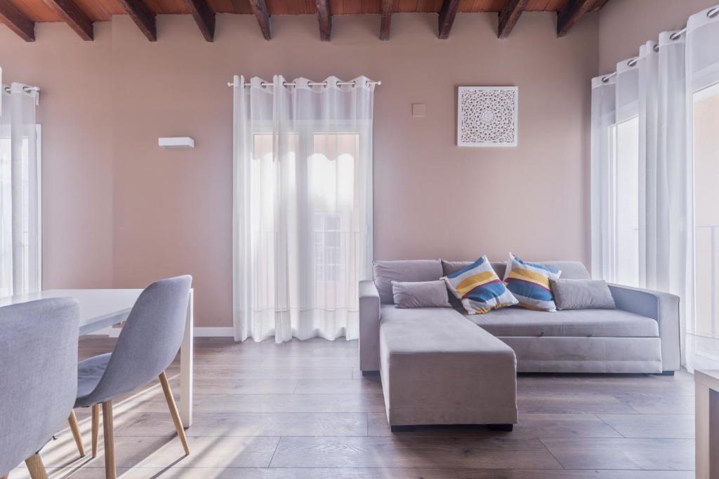 a living room with a couch and a table at San Miguel, Luxury apartments. in Valencia