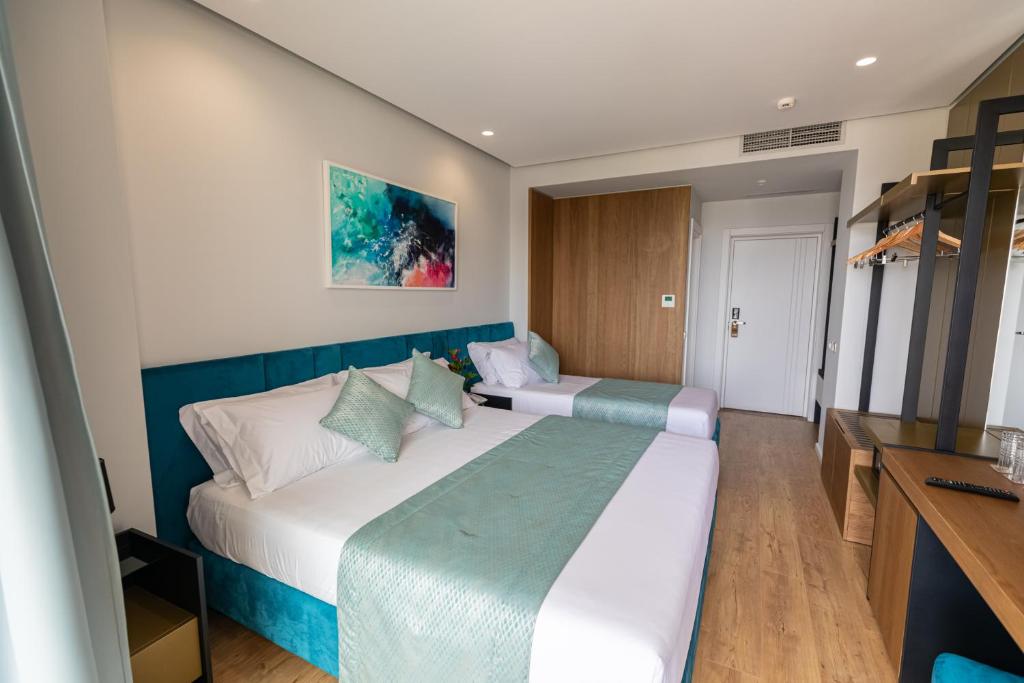 Postel nebo postele na pokoji v ubytování Ames Hotel & SPA
