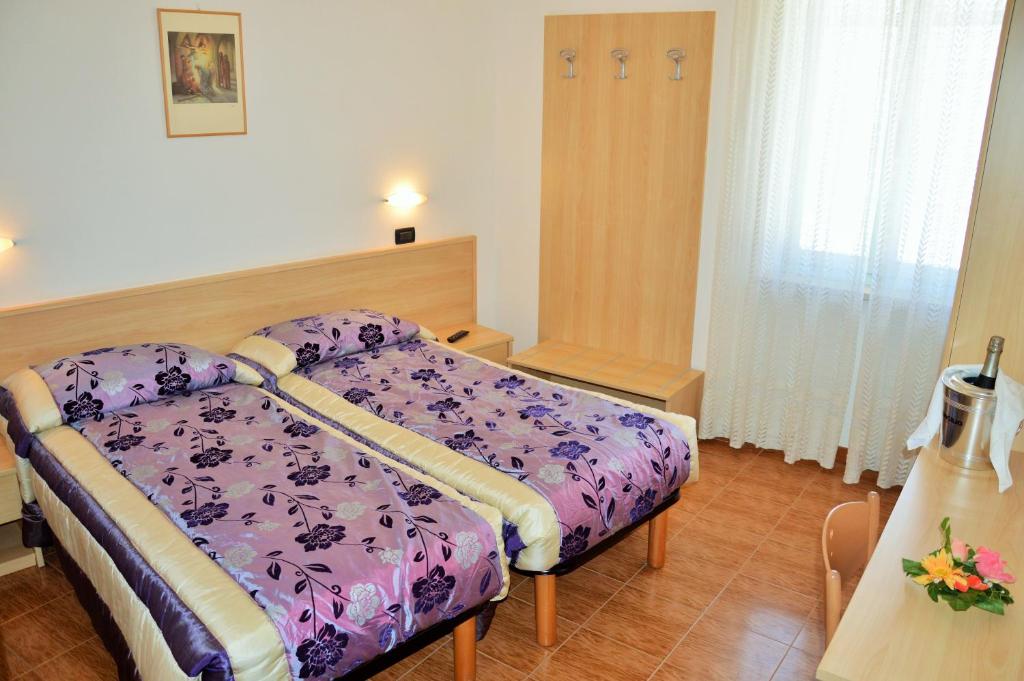 Postel nebo postele na pokoji v ubytování Albergo Neni