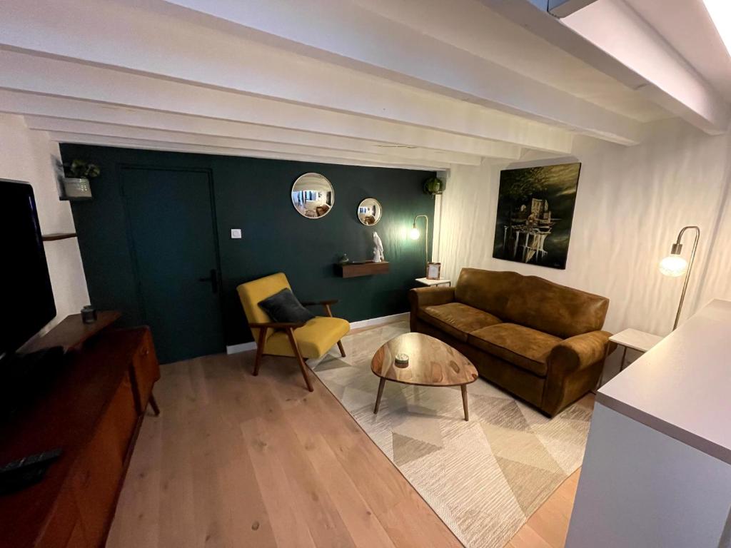 - un salon avec un canapé et une table dans l'établissement Charmant et spacieux studio (T1bis) - Bordeaux, Chartrons, à Bordeaux