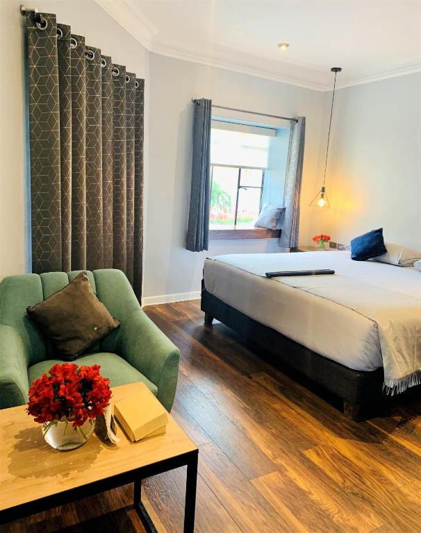 Hotel Casa Montes San Blas, a bedroom with a bed and a couch and a table at Casa Montes San Blas in Cusco