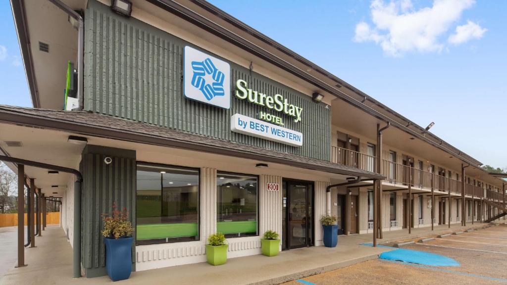 a building with a sign on the side of it at SureStay Hotel by Best Western Jasper in Jasper