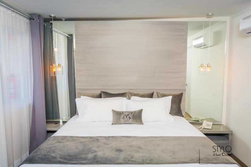 Säng eller sängar i ett rum på Hotel Monumental
