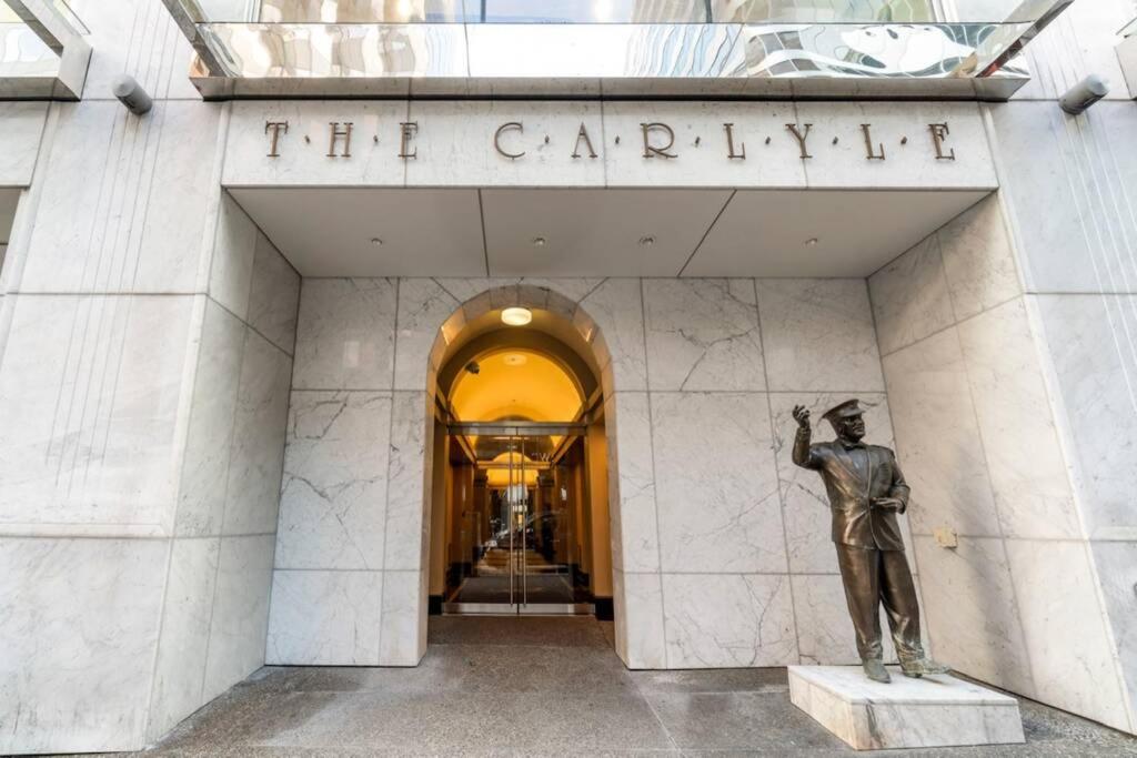 a statue of a man standing in front of a building at Your Vacation Home Downtown Vancouver in Vancouver