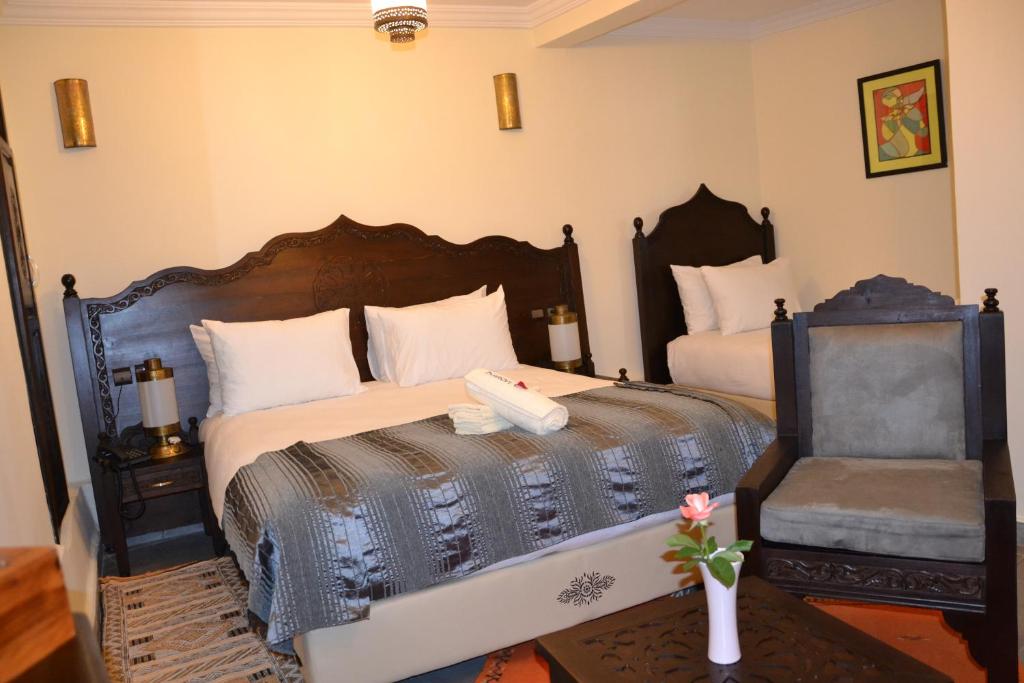 Postel nebo postele na pokoji v ubytování Hotel Riad Ben Atar