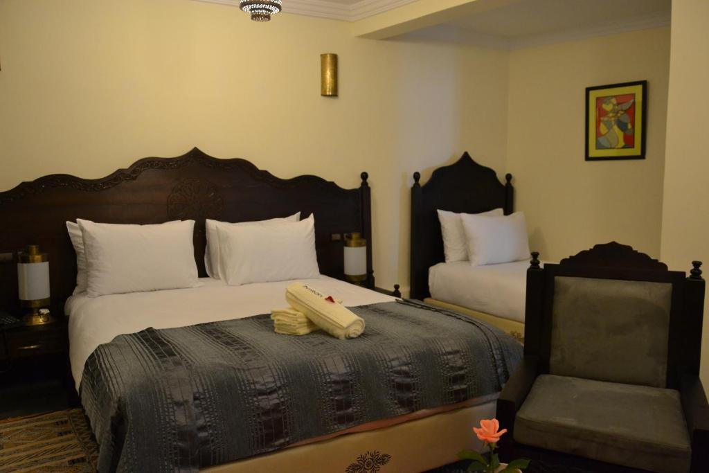 Postel nebo postele na pokoji v ubytování Hotel Riad Ben Atar