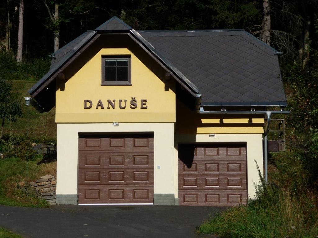a garage with a sign that reads dance at Chata Danuše in Ludvíkov