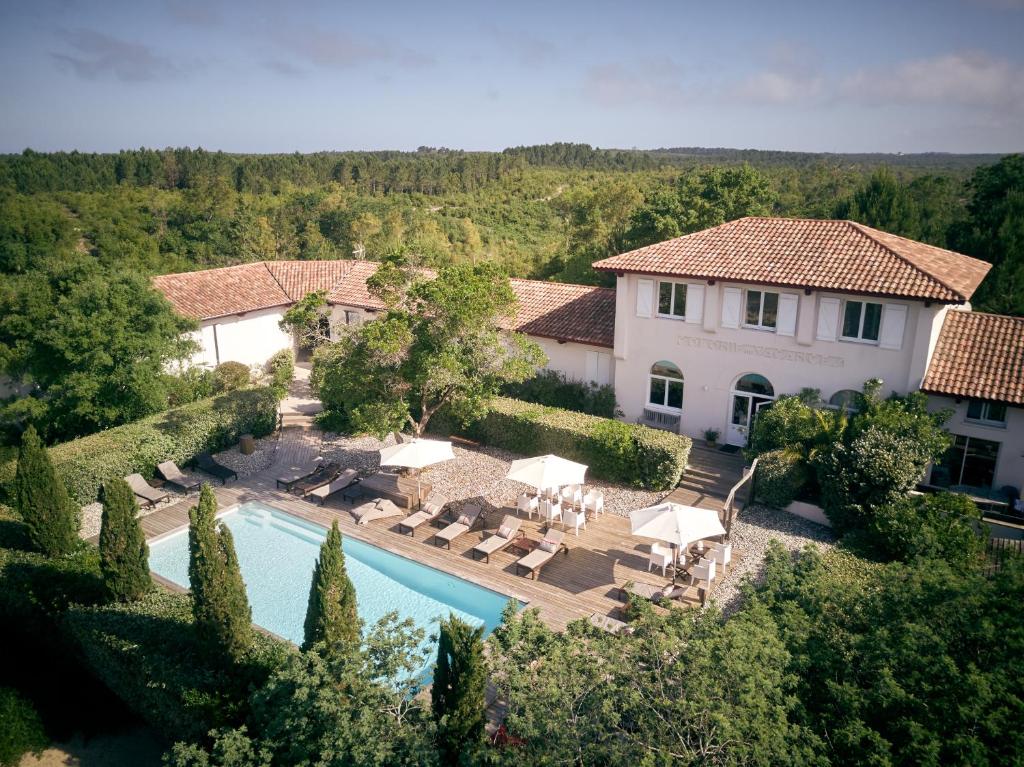 an aerial view of a house with a swimming pool at Hotel La Maison de la Prade in Messanges
