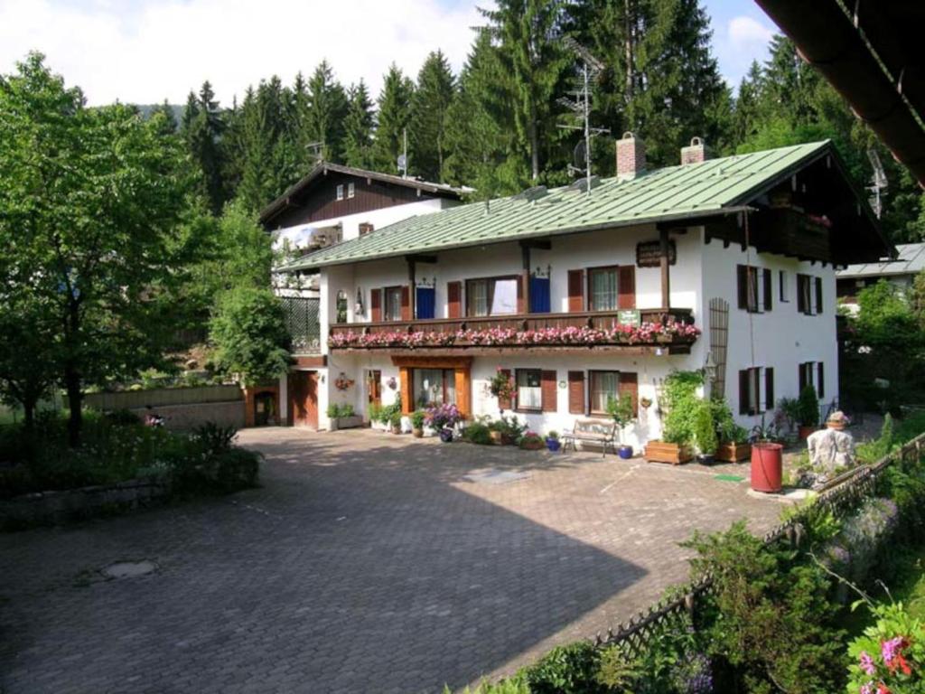 a large white house with a driveway in front of it at Gästehaus Schwaiger in Schönau am Königssee