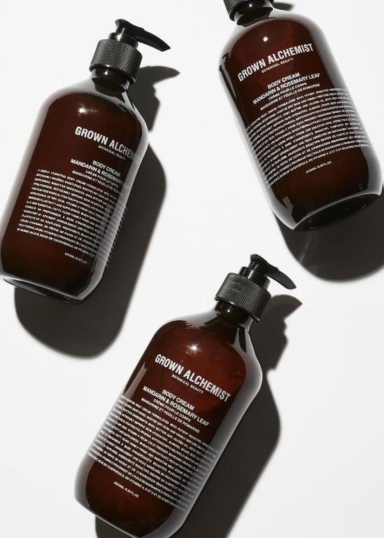 a group of three bottles of hair products on a white background at Pénde Suites in Livadion