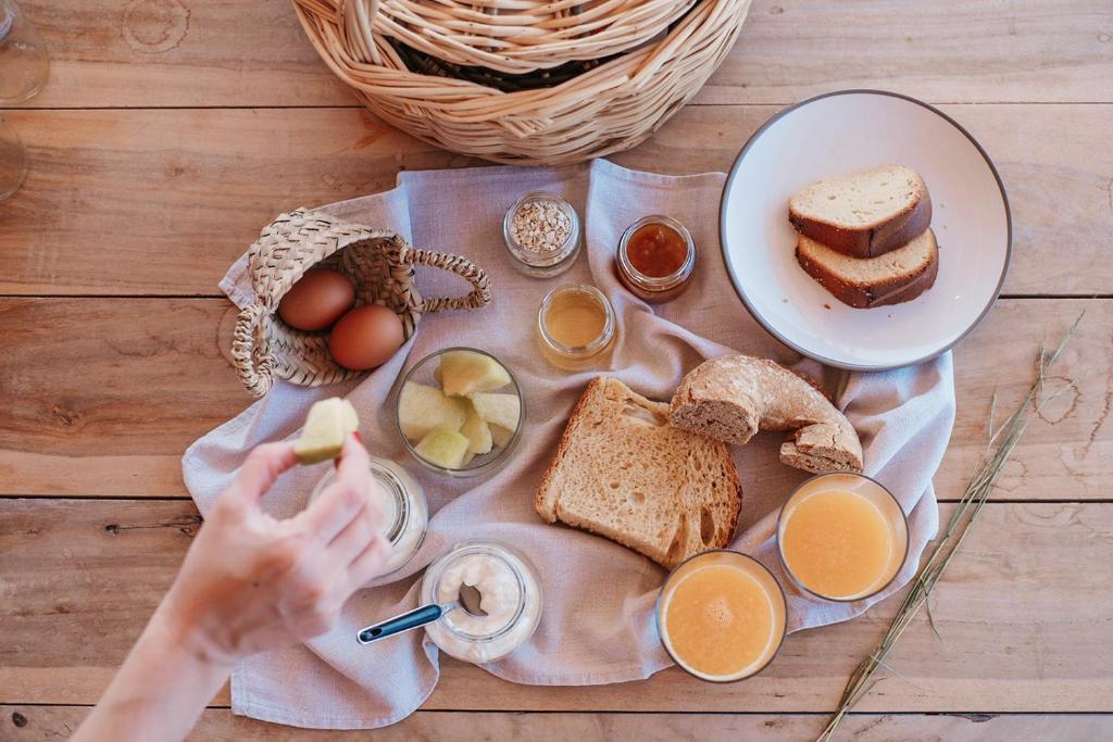 a table with eggs bread and other food on it at Pénde Suites in Livadion