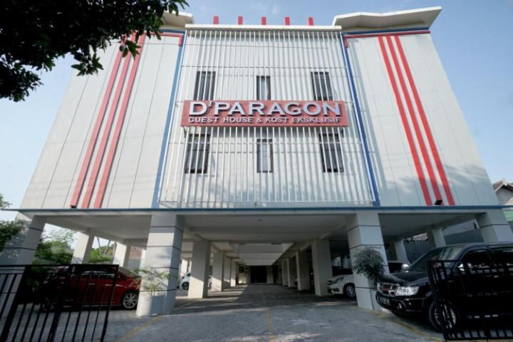 a large building with a red and white sign on it at D'Paragon Manduro in Solo