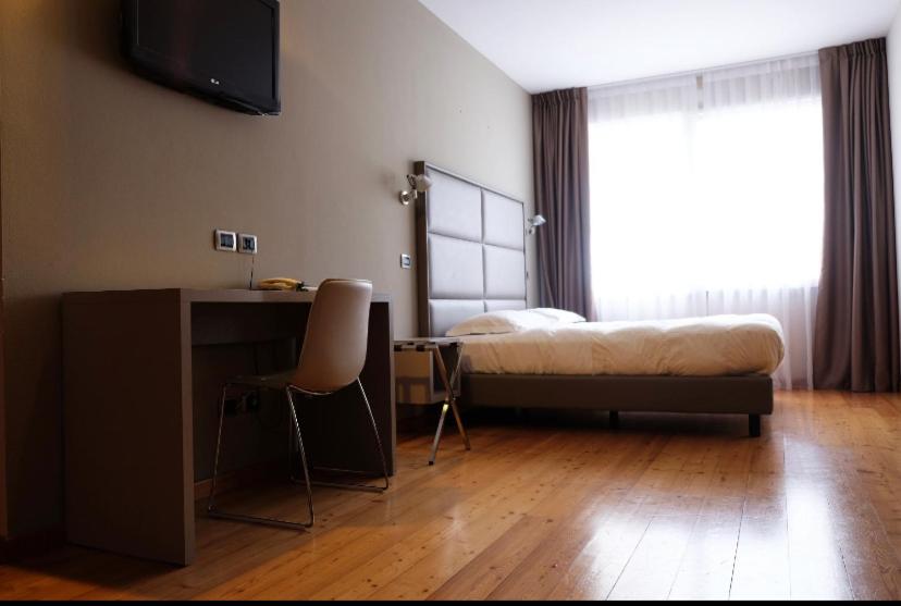 Postel nebo postele na pokoji v ubytování Hotel Rubicone