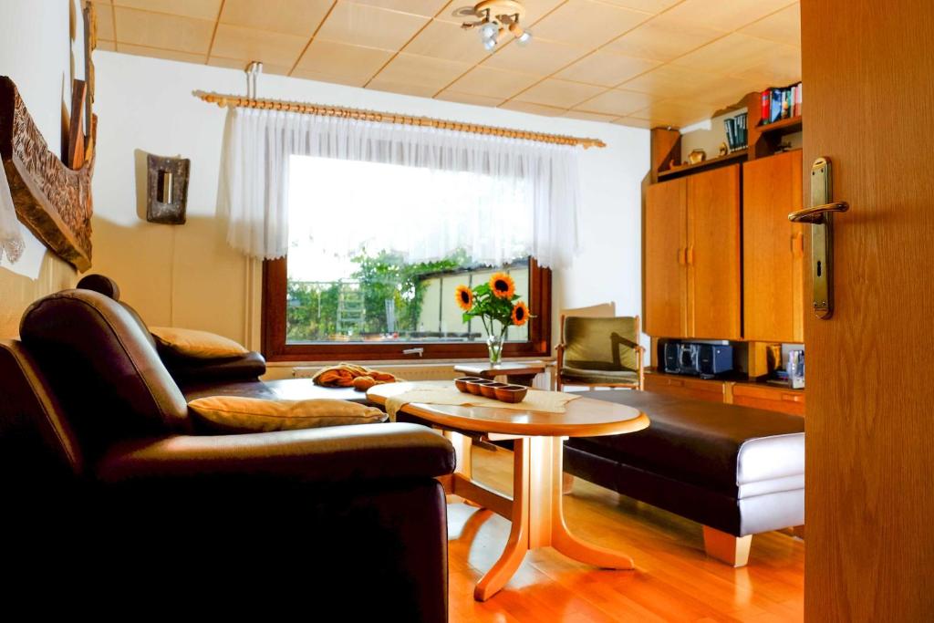 a living room with a couch and a table at Ferienhaus an der Orther Reede in Fehmarn