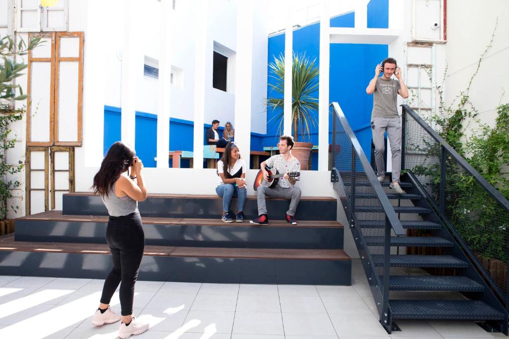a group of people sitting on stairs in a building at Résidence Kley in Marseille