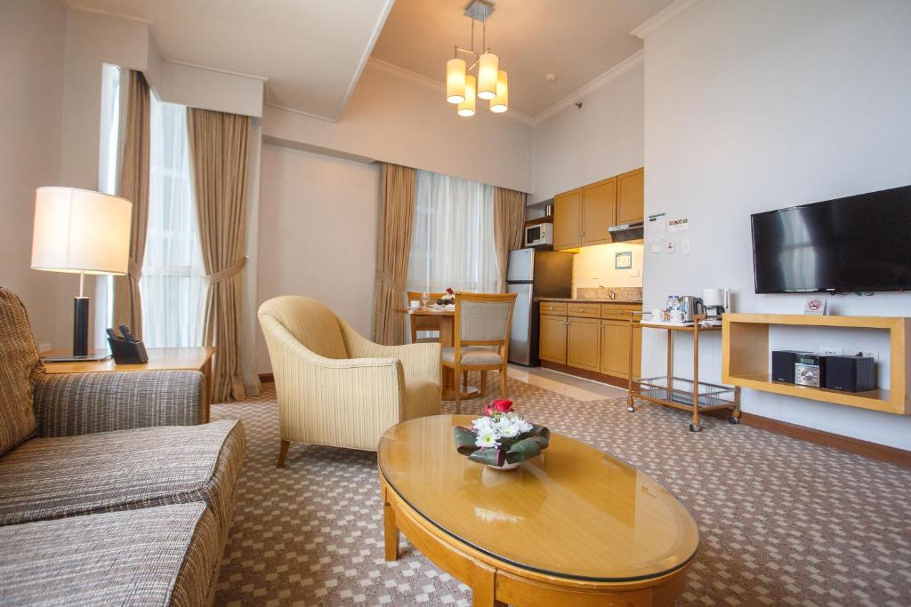 a living room with a couch and a table at The Linden Suites in Manila