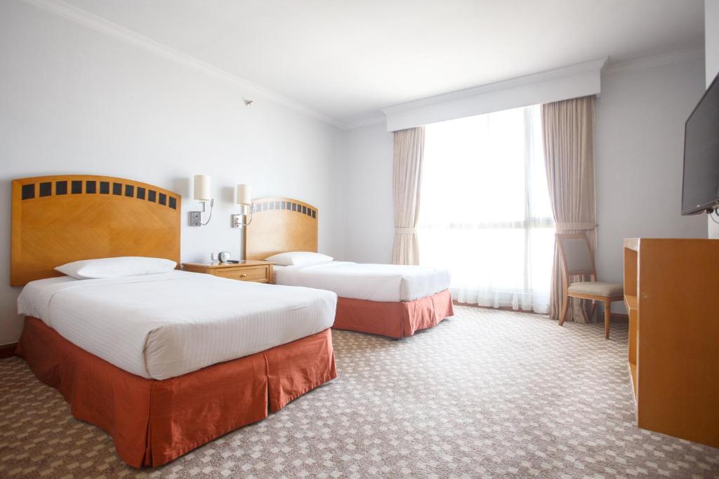Postel nebo postele na pokoji v ubytování The Linden Suites
