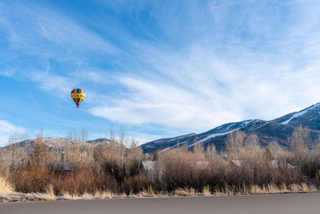 a kite flying in the sky over a body of water at La Quinta Inn by Wyndham Steamboat Springs in Steamboat Springs