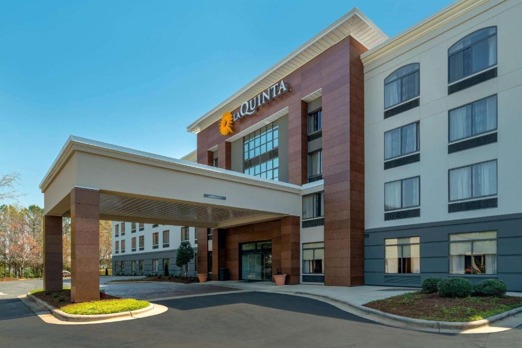 a rendering of the front of a hotel at La Quinta by Wyndham Raleigh Downtown North in Raleigh