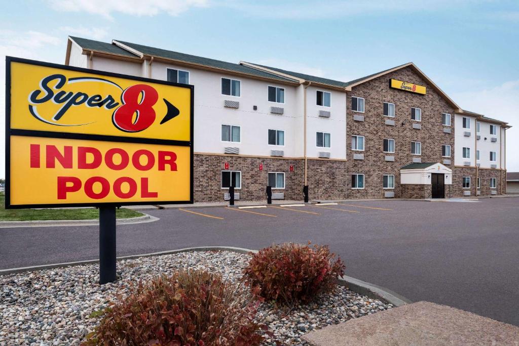 an indoor pool sign in front of a building at Super 8 by Wyndham Sioux Falls in Sioux Falls