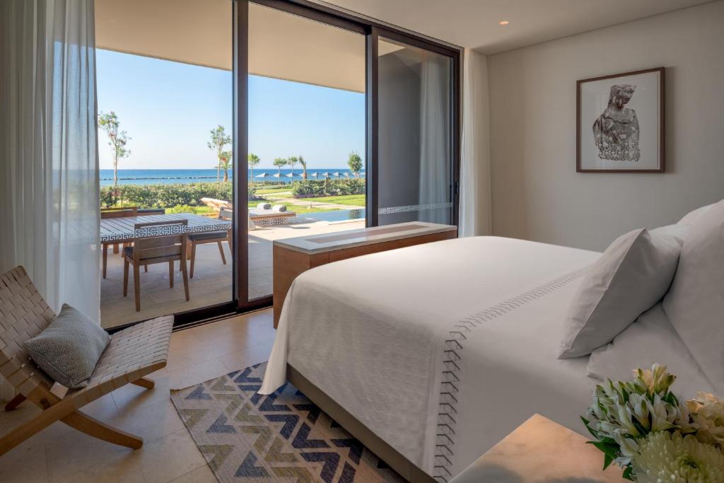 a bedroom with a bed and a view of the ocean at Amara - Sea Your Only View™ in Limassol
