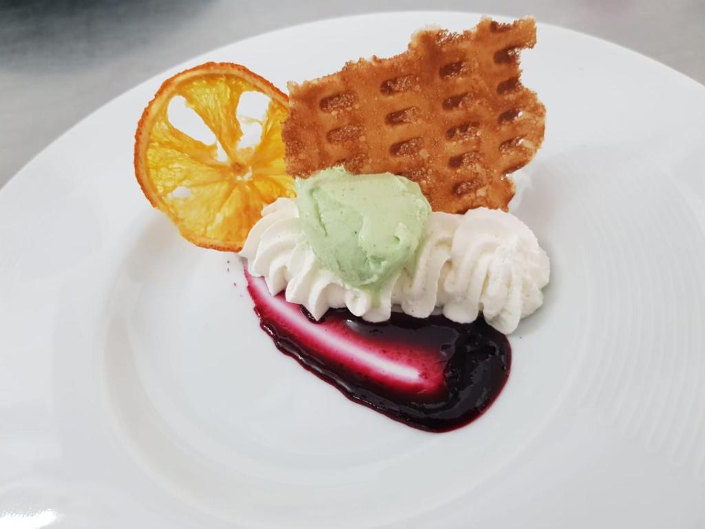 a plate of food with a hot dog and waffles at Luna Convento Copanello B&B in Stalettì
