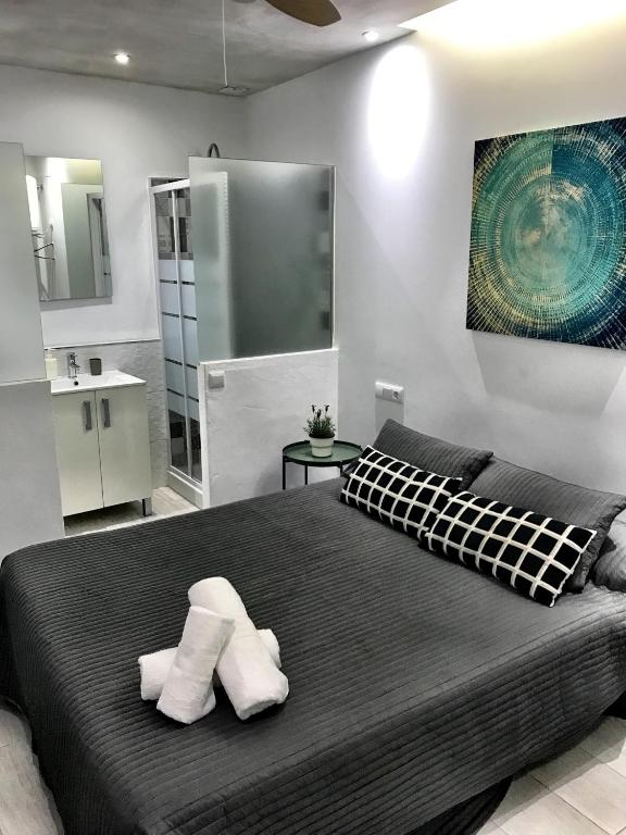 a bedroom with a large bed with two pillows at Tarifa Bed and Center in Tarifa