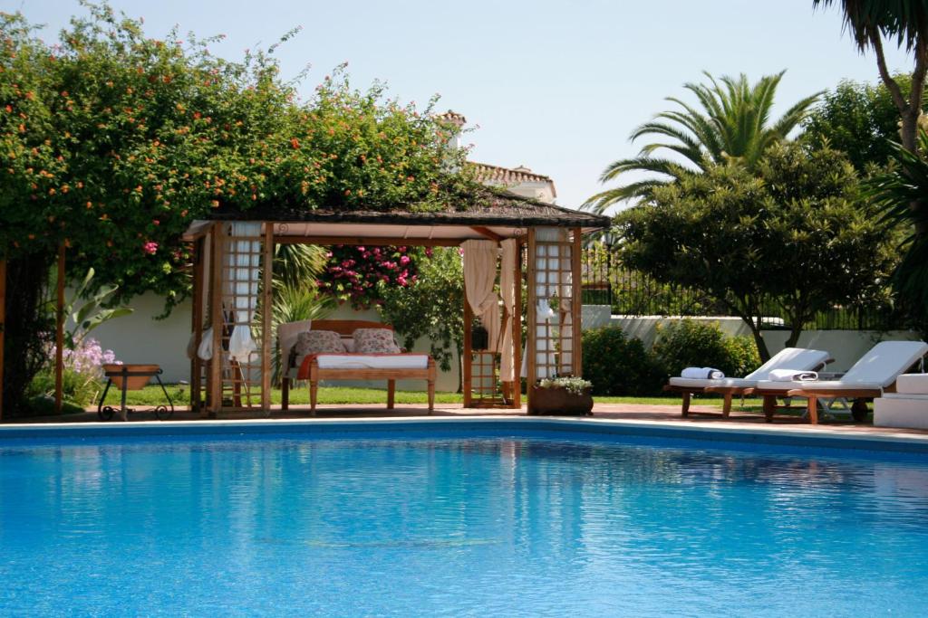 a pool with a pool table and chairs in it at Casa la Concha Boutique Hotel in Marbella